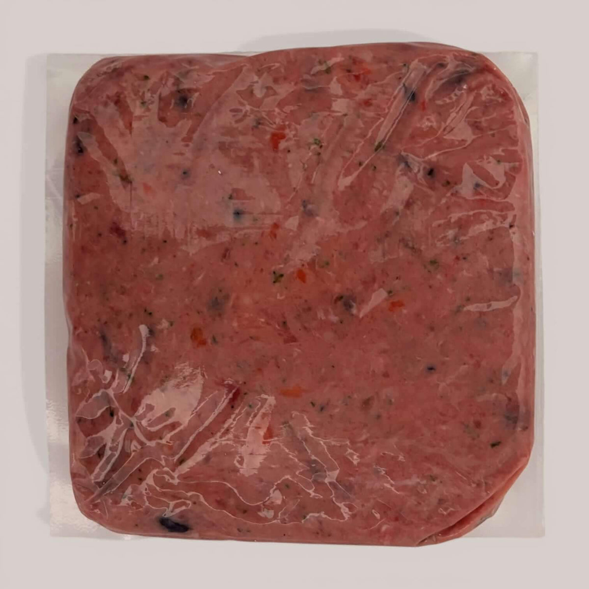 Back of Carnevore Mountain Duck and Turkey raw dog food in plastic packaging on a white background