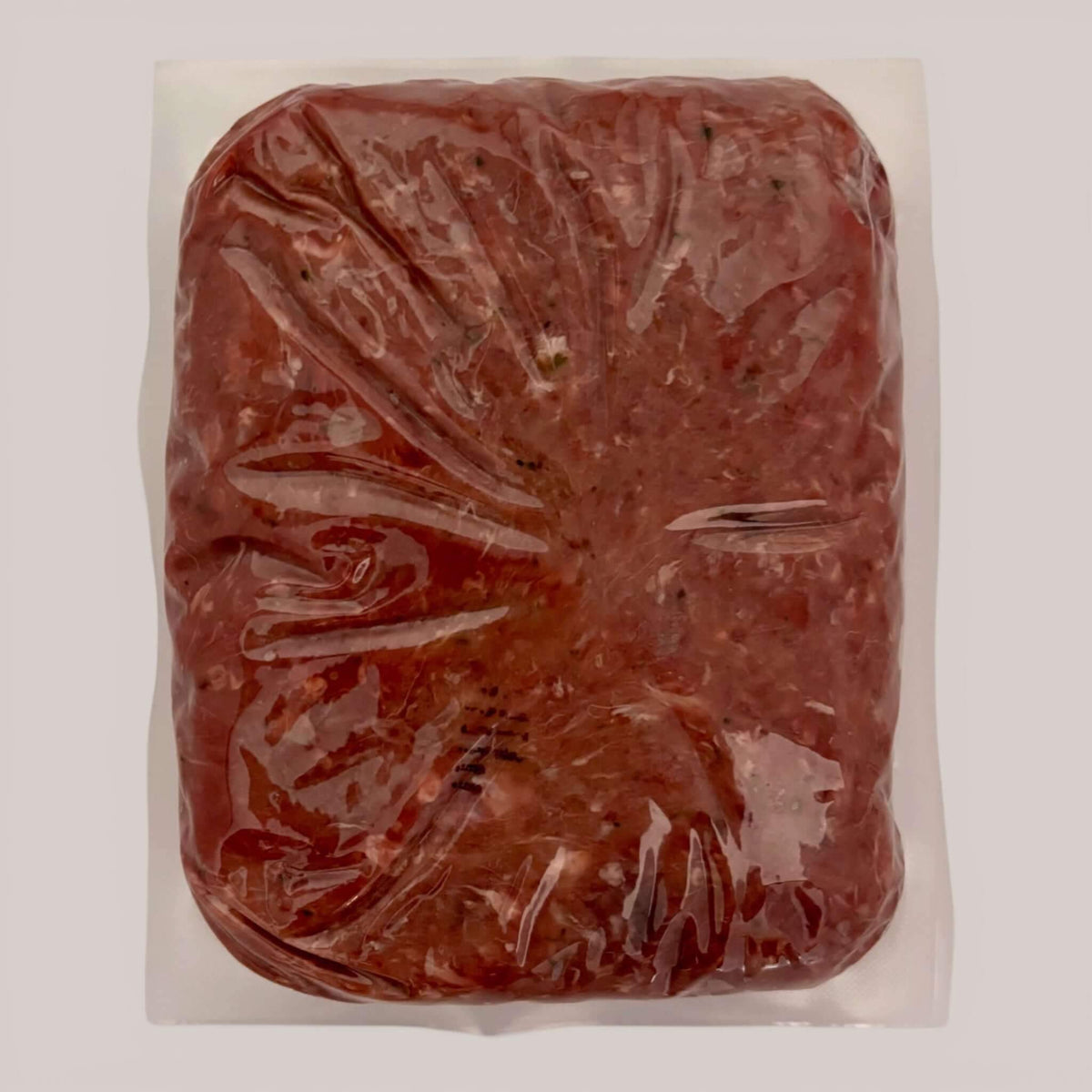 Carnevore Mountain raw dog food in plastic packaging on a white background