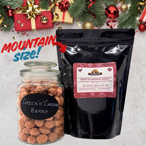 Jar and black bag of 'Chick'n Cheddar Berry' with Christmas decorations in the background