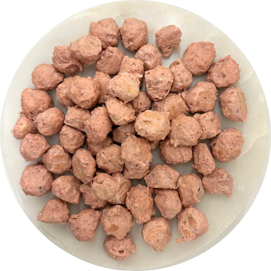Chicken cheese cranberry dog treats in a round dish, featuring Chick’n Cheddar & Gouda Crunch bites.