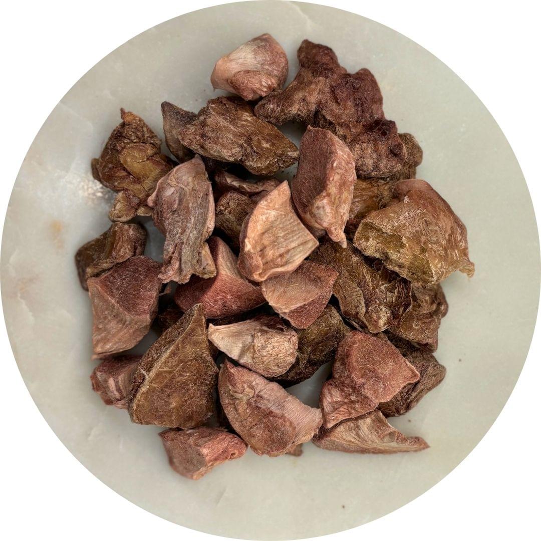Picture of freeze dried chicken giblets on a white plate.