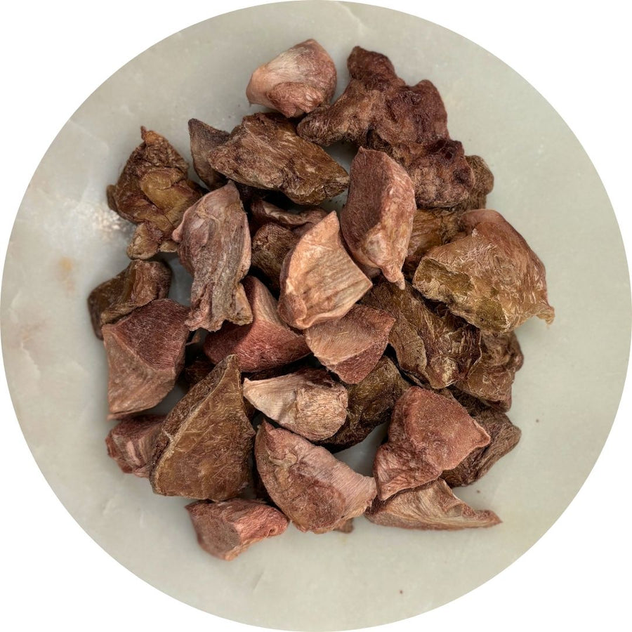 Picture of freeze dried chicken giblets on a white plate.