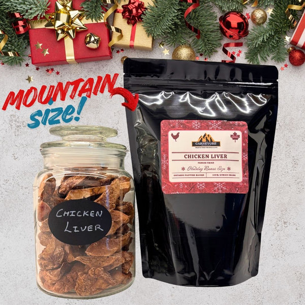 Two packages of chicken liver with Christmas decorations in the background