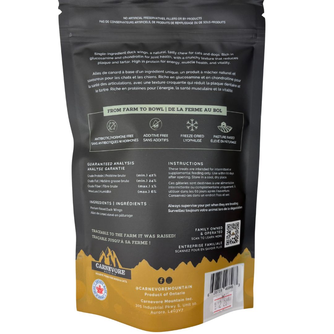 Freeze dried duck wings dog treats packaging with ingredient analysis and feeding instructions.