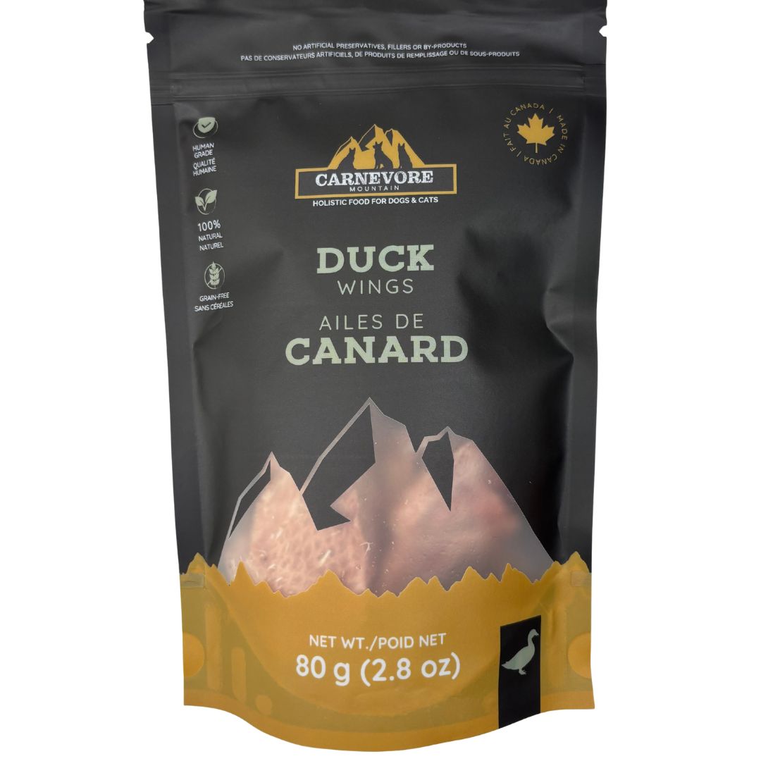 Freeze dried duck wings dog treats in a resealable bag, featuring a mountain design and nutritional information.