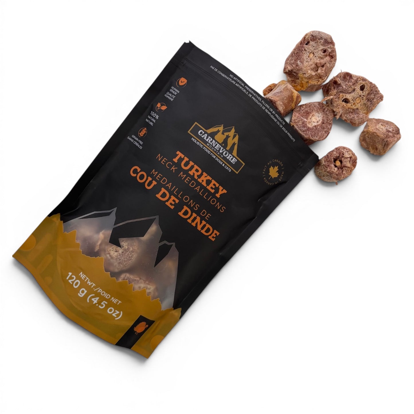 Pieces of Carnevere Mountain freeze dried turkey neck medallions  dog treats in open package on a white background
