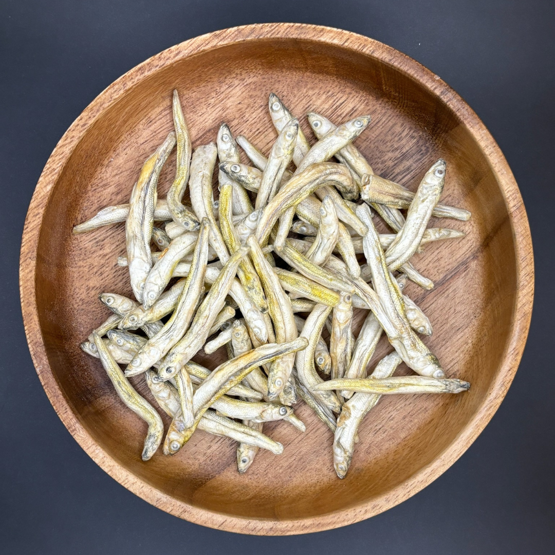 Photo of Canrevore Mountain freeze dried Great Lakes Smelt human grade dog treats in a brown bowl with blue background.