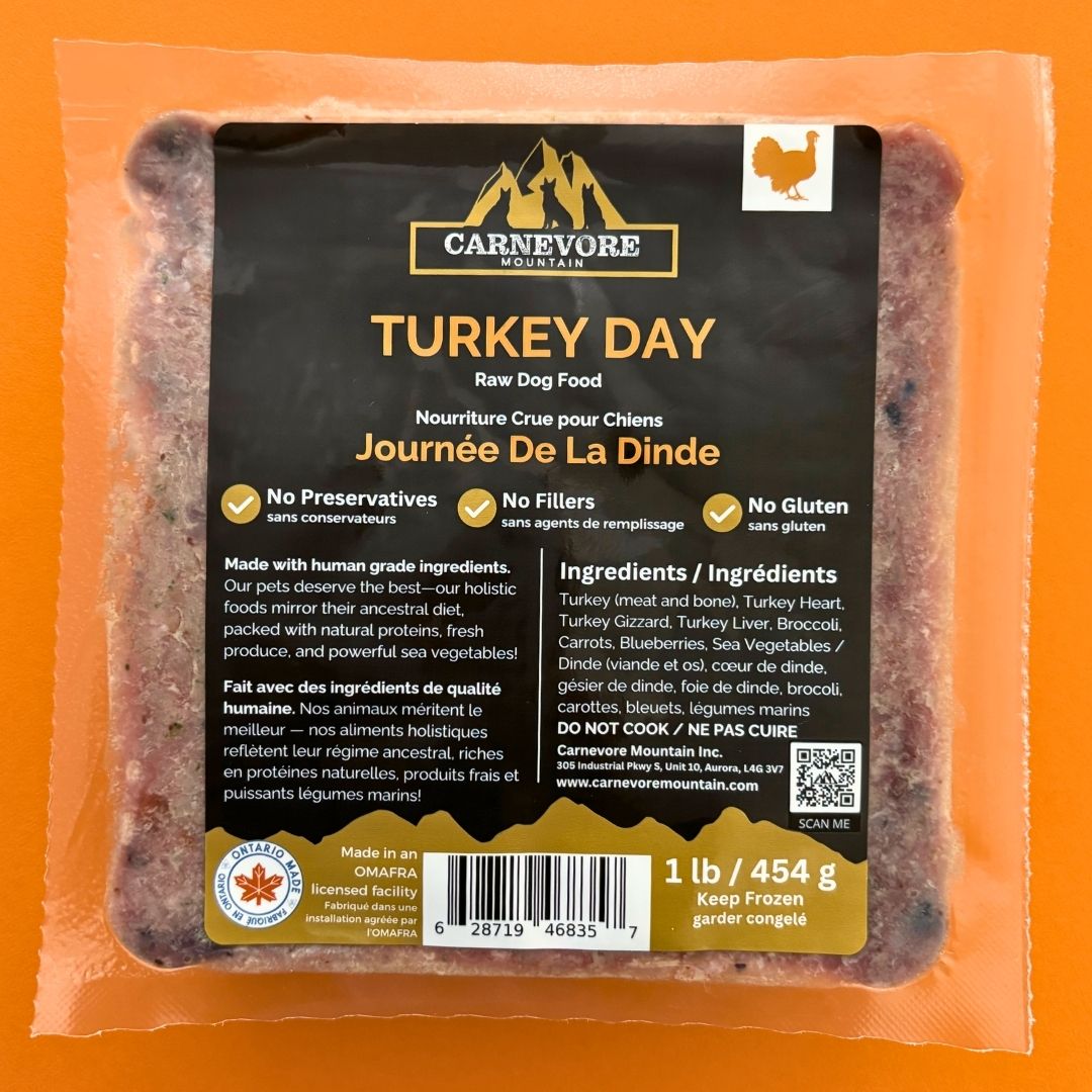 Carnevore Mountain turkey day raw dog food package on an orange background