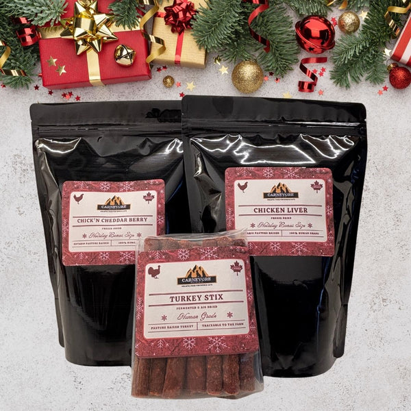 Dog treat packages with labels on a festive background with Christmas decorations.